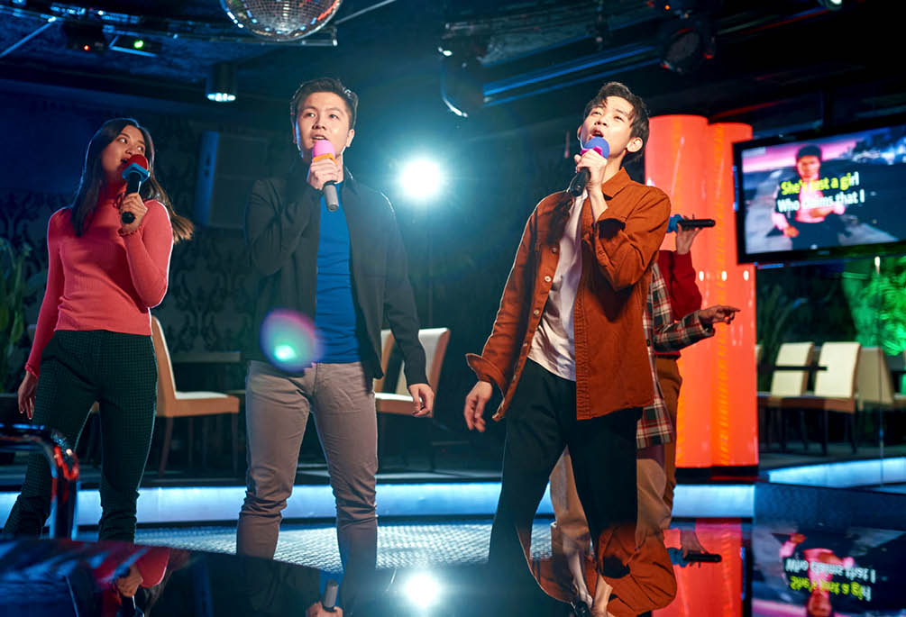 Singing songs karaoke and dancing on night club stage, njoying friendship together in bar, Concept of party, holiday, relaxation, Spend day-off in karaoke together with friends, enjoy time in club