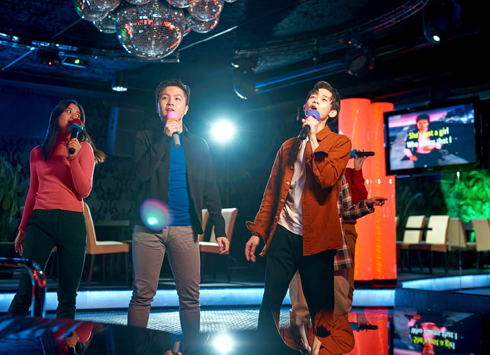 Singing songs karaoke and dancing on night club stage, njoying friendship together in bar, Concept of party, holiday, relaxation, Spend day-off in karaoke together with friends, enjoy time in club